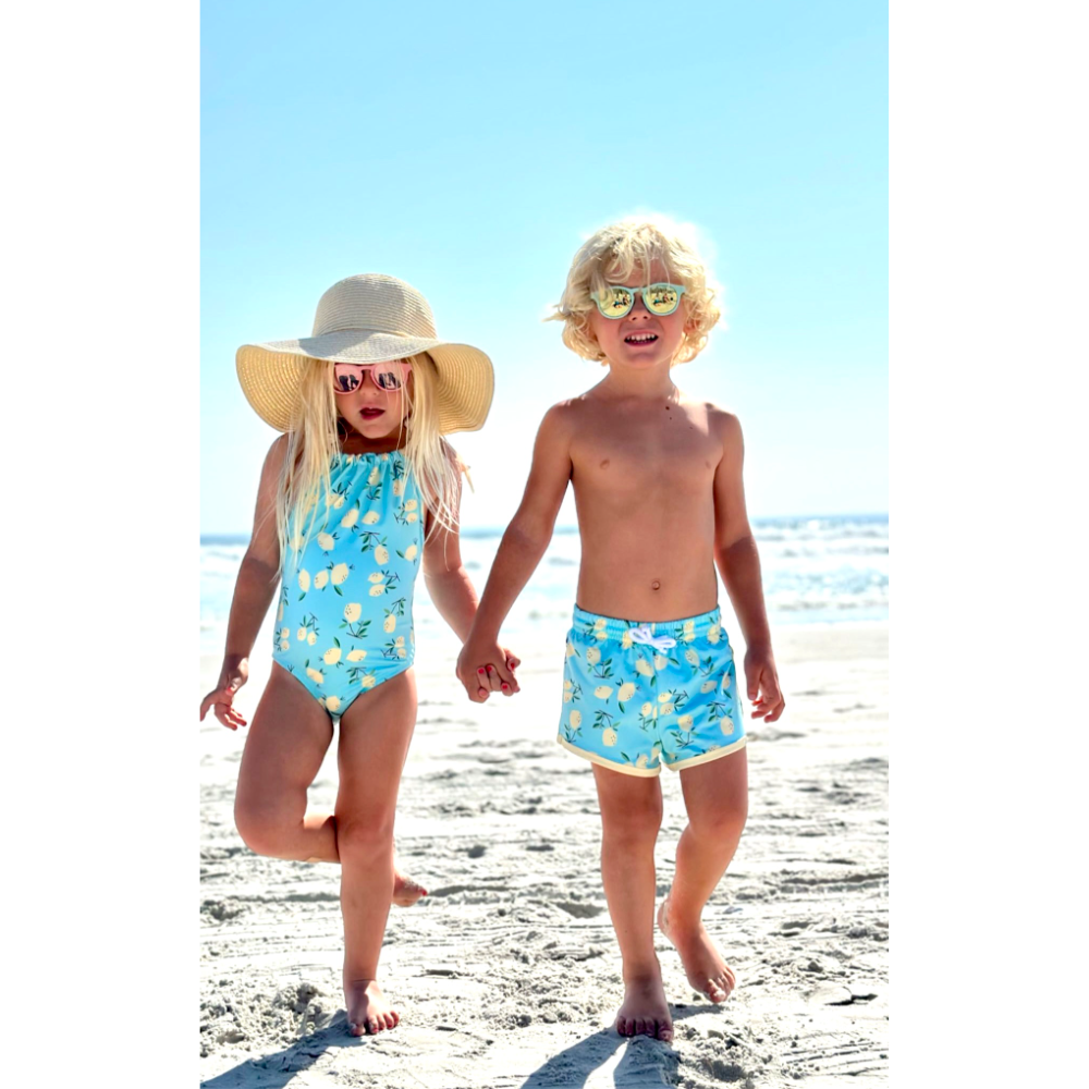 Boy & Girl in swimwear with teal lemons