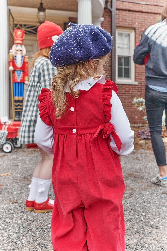 little girl wearing Red Corduroy Berkley Overall in snow