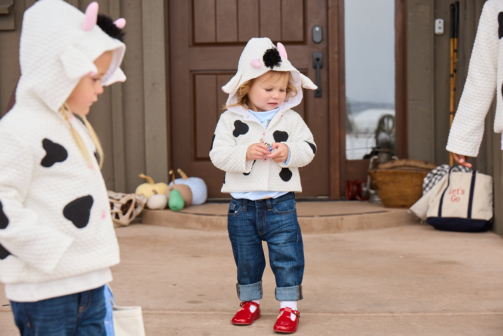 toddlers wearing cow printed coat