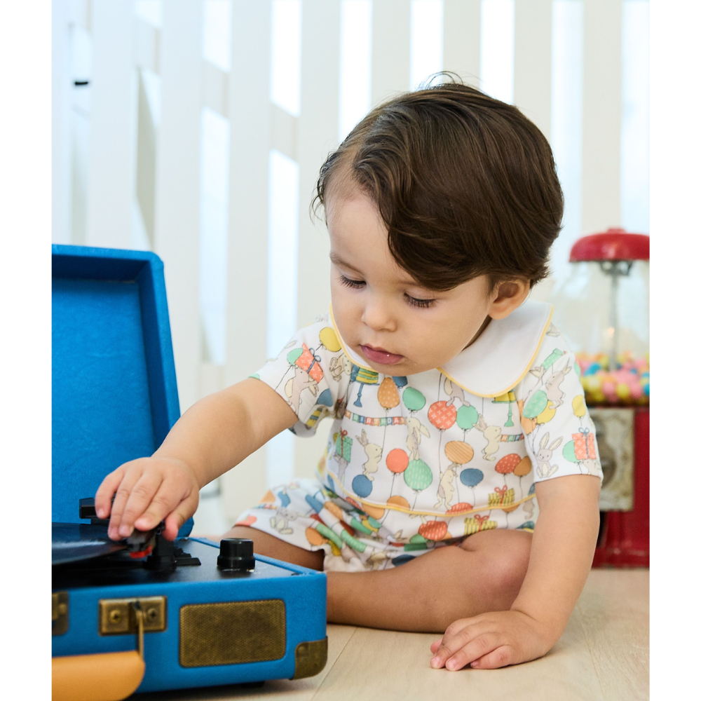 baby boy playing with record player in birthday bunny Finn Pima Romper