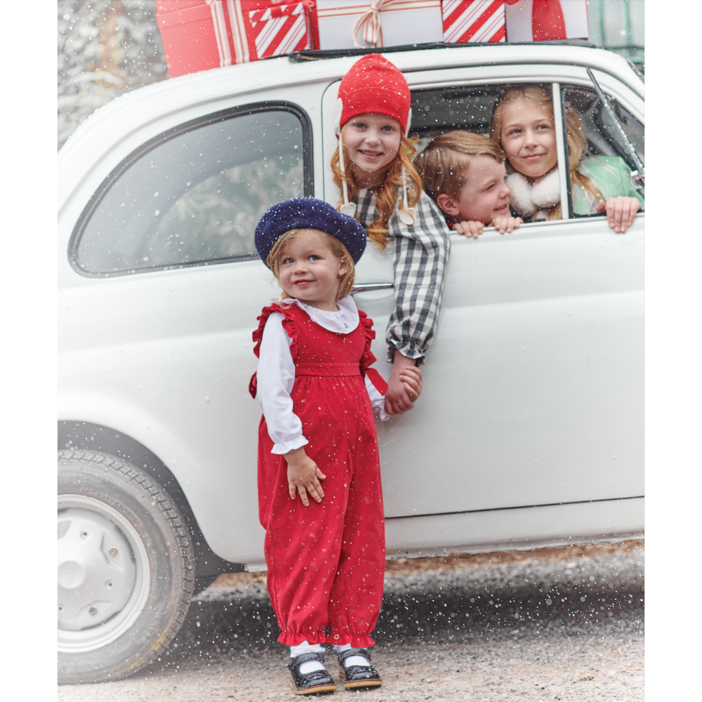 little girl wearing Red Corduroy Berkley Overall in front of car